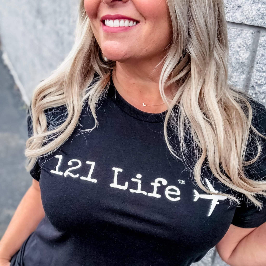 Blonde flight attendant wearing part 121 tee in black