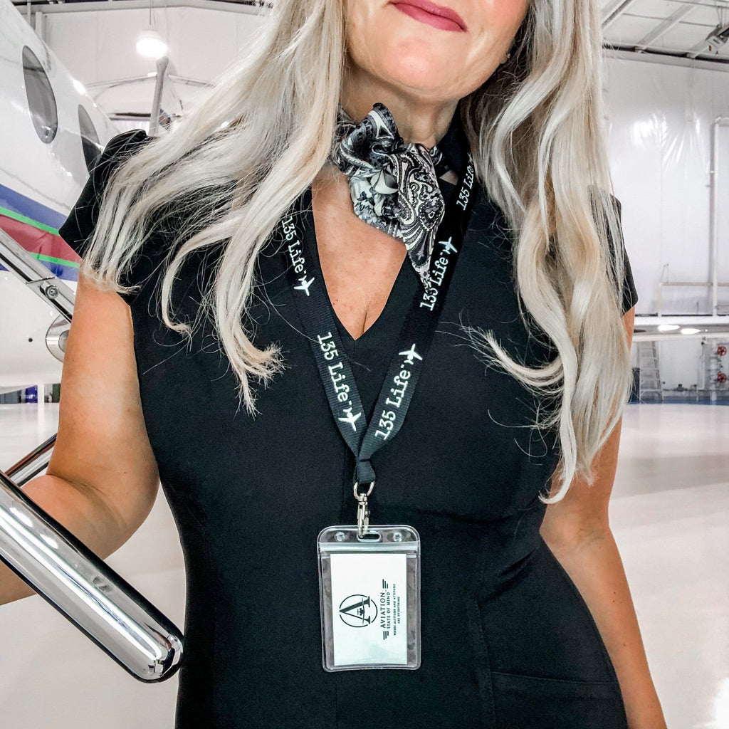 blonde flight attendant wearing part 135 lanyard