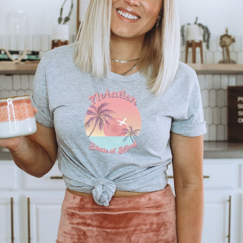 girl with coffee cup w gray tshirt w sunset airplane design